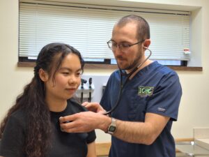 Clinic provider performs routine checkup on a patient