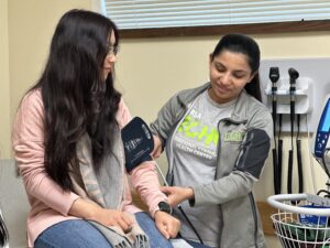 A medical assistant takes a patient's blood pressure
